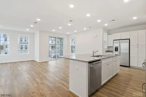 a kitchen with stainless steel appliances granite countertop a sink and stove