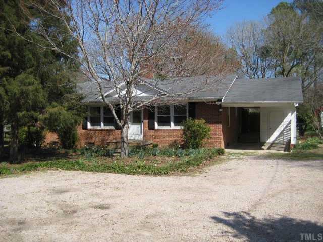 5113 Old Stage Road Raleigh, NC 27603 - Photo 1 of 12 a front view of a house with garden and trees