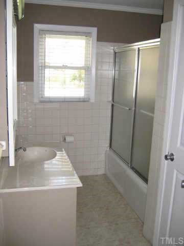 5113 Old Stage Road Raleigh, NC 27603 - Photo 7 of 12 a bathroom with a sink a bathtub and a shower
