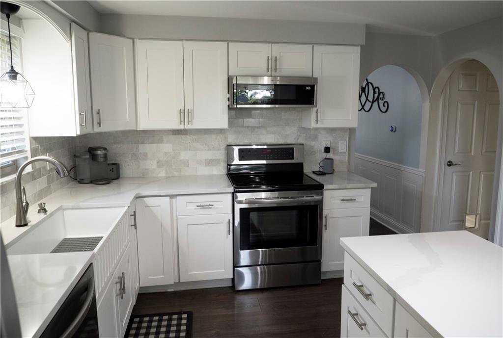 102 Bertley Ridge Drive Coraopolis, PA 15108 - Photo 6 of 25 a kitchen with a sink stove and cabinets