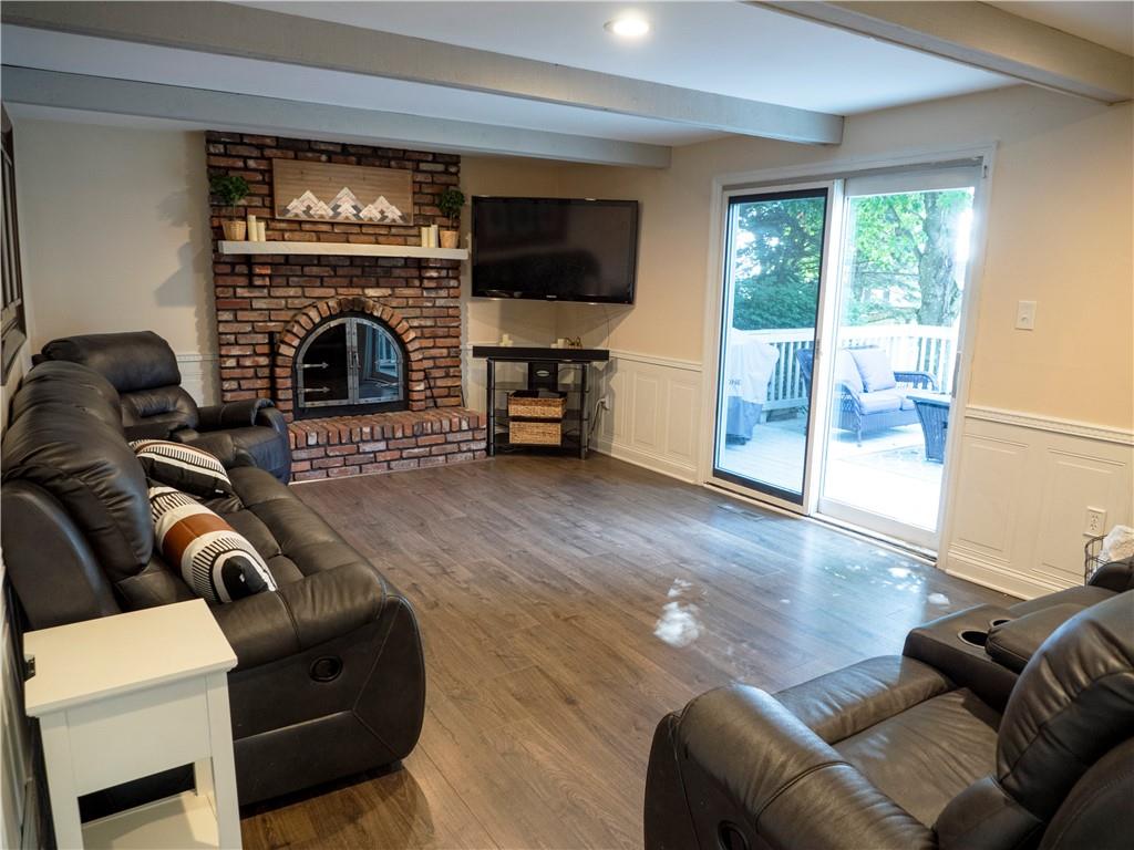 102 Bertley Ridge Drive Coraopolis, PA 15108 - Photo 10 of 25 a living room with furniture a fireplace and a flat screen tv