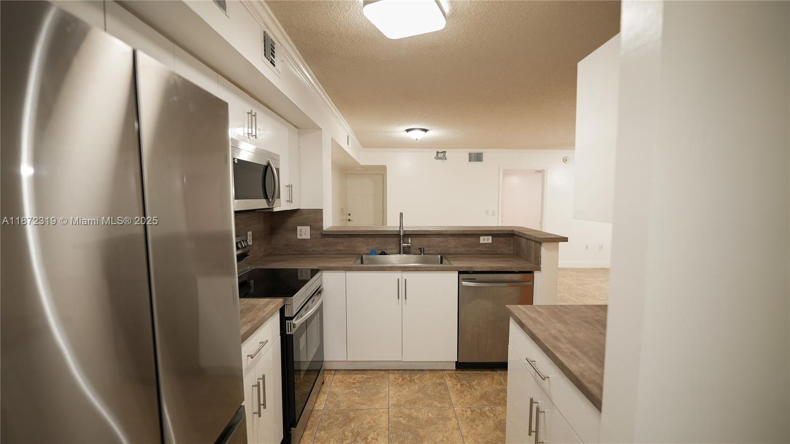 a kitchen with a sink cabinets and stainless steel appliances