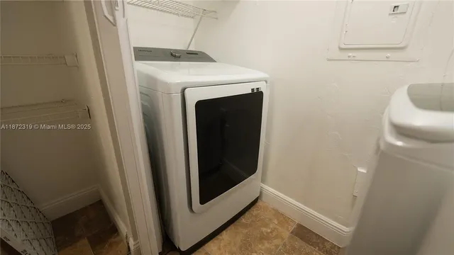 a kitchen with stainless steel appliances kitchen island granite countertop a refrigerator and a stove top oven