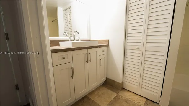 a view of a small space with wooden floor and a window