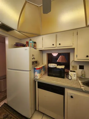 a kitchen with stainless steel appliances a refrigerator sink and cabinets