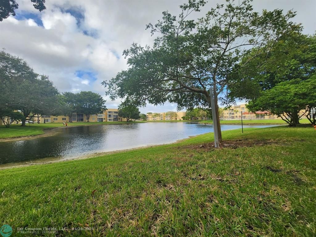 5851 Northwest 62nd Avenue, Unit 105 Tamarac, FL 33319 - Photo 13 of 18 a view of lake with green space