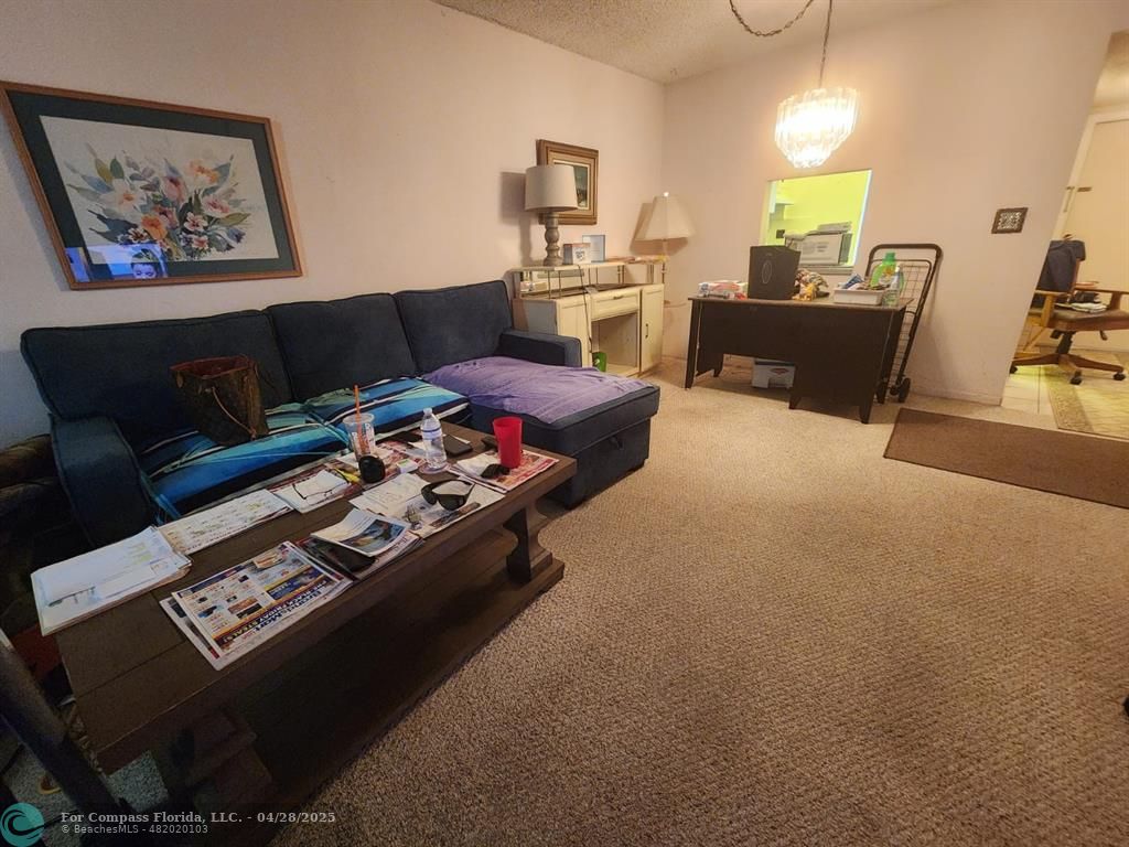 5851 Northwest 62nd Avenue, Unit 105 Tamarac, FL 33319 - Photo 2 of 18 a living room with furniture and a couch