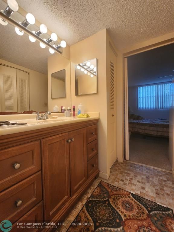 5851 Northwest 62nd Avenue, Unit 105 Tamarac, FL 33319 - Photo 6 of 18 a bathroom with a sink and a mirror