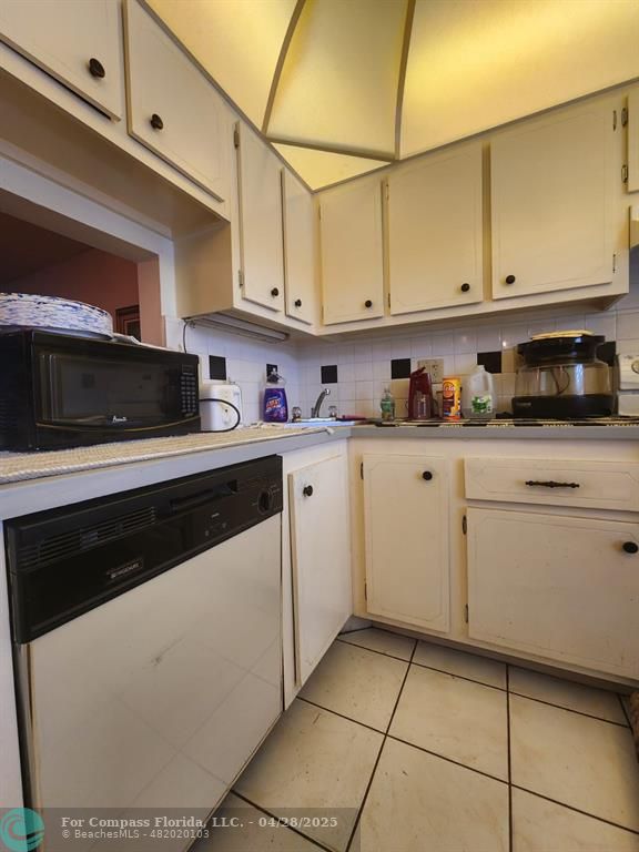 5851 Northwest 62nd Avenue, Unit 105 Tamarac, FL 33319 - Photo 9 of 18 a kitchen with stainless steel appliances granite countertop a sink a stove and cabinets