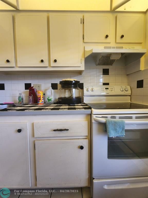 5851 Northwest 62nd Avenue, Unit 105 Tamarac, FL 33319 - Photo 10 of 18 a kitchen with stainless steel appliances granite countertop a sink and cabinets