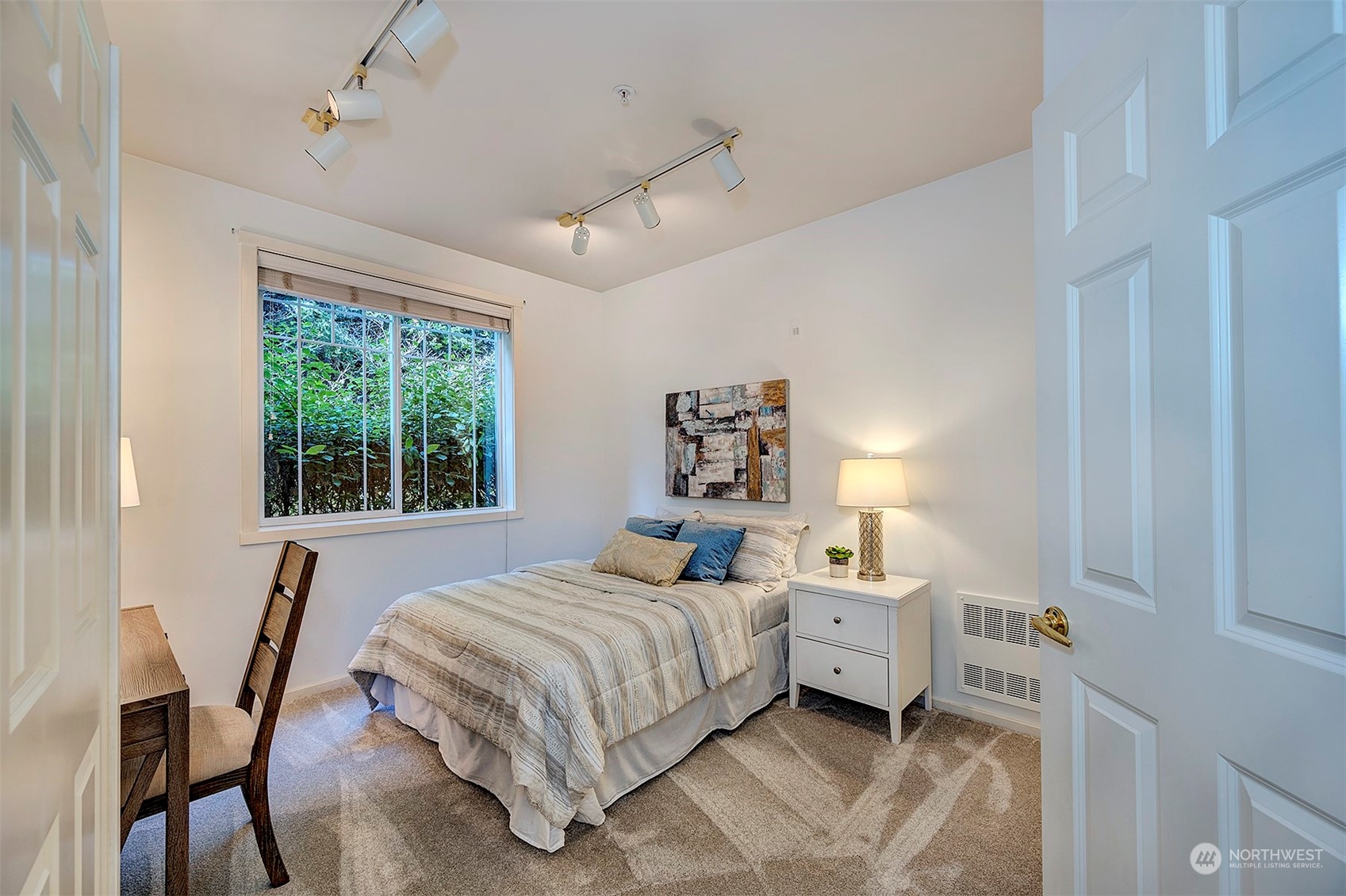 555 Anacortes Court Northeast, Unit 101 Renton, WA 98059 - Photo 17 of 22 a bedroom with a bed next to a window and a chair