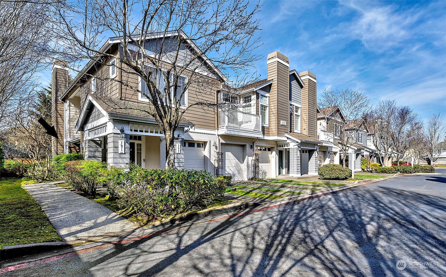 555 Anacortes Court Northeast, Unit 101 Renton, WA 98059 - Photo 3 of 22 a front view of a house with a yard and potted plants