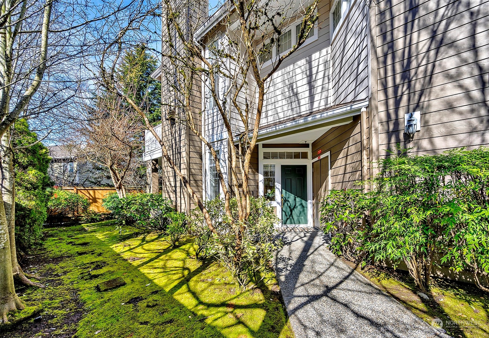 555 Anacortes Court Northeast, Unit 101 Renton, WA 98059 - Photo 4 of 22 a yellow building with trees in front of it