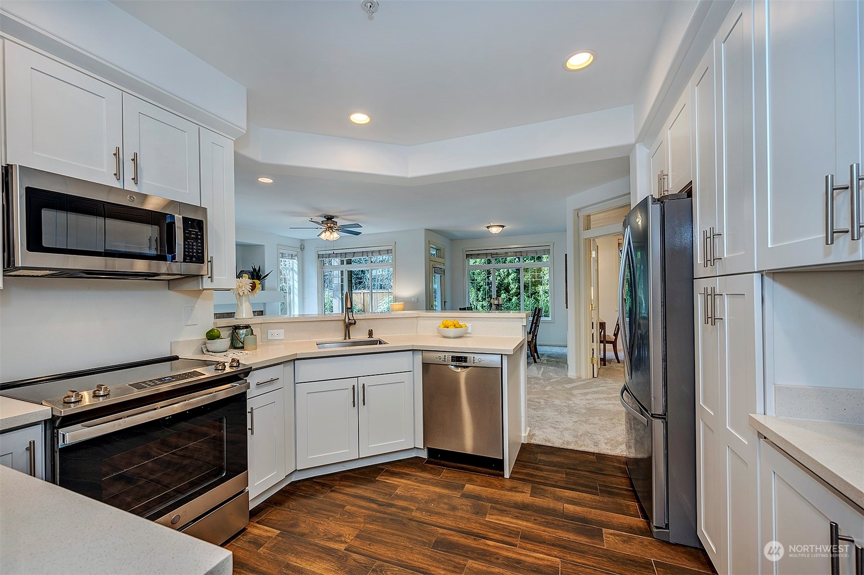 555 Anacortes Court Northeast, Unit 101 Renton, WA 98059 - Photo 9 of 22 a kitchen with stainless steel appliances a stove a sink and a microwave