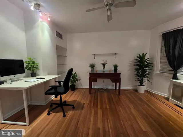 a workspace with furniture window and wooden floor