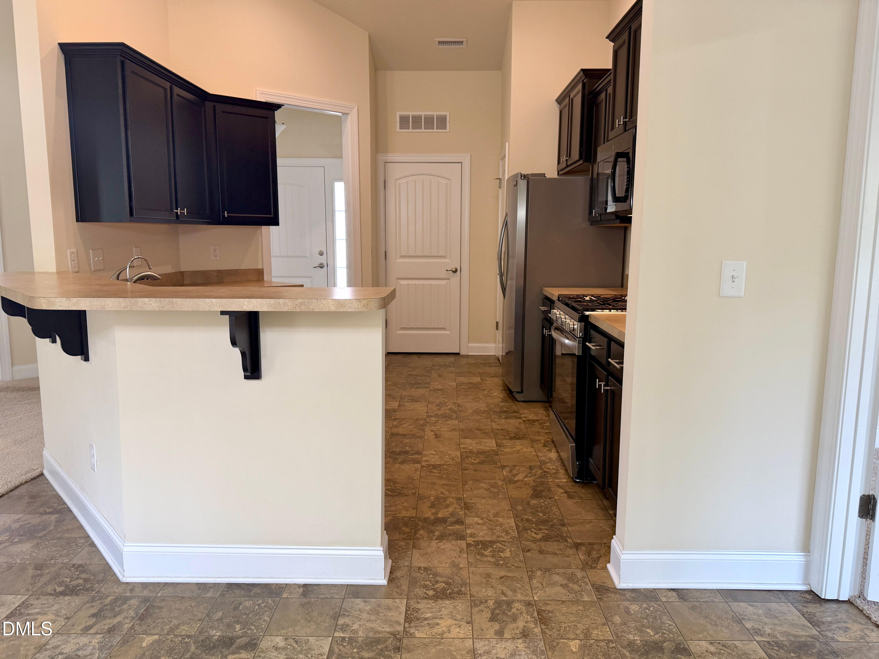 15 Cedar Falls Way Angier, NC 27501 - Photo 13 of 56 a kitchen with granite countertop a refrigerator stove and sink