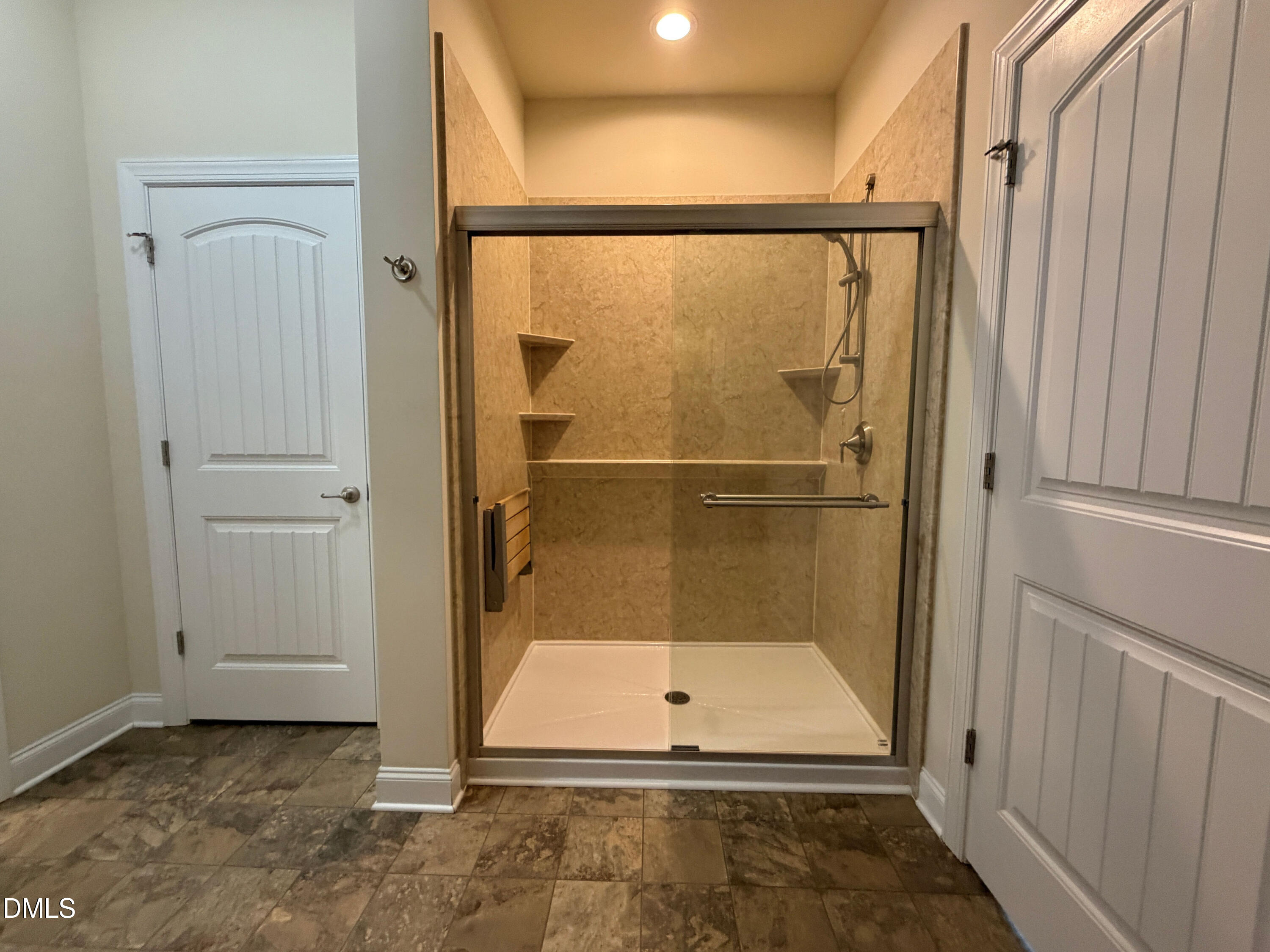 15 Cedar Falls Way Angier, NC 27501 - Photo 23 of 56 a bathroom with a glass shower door