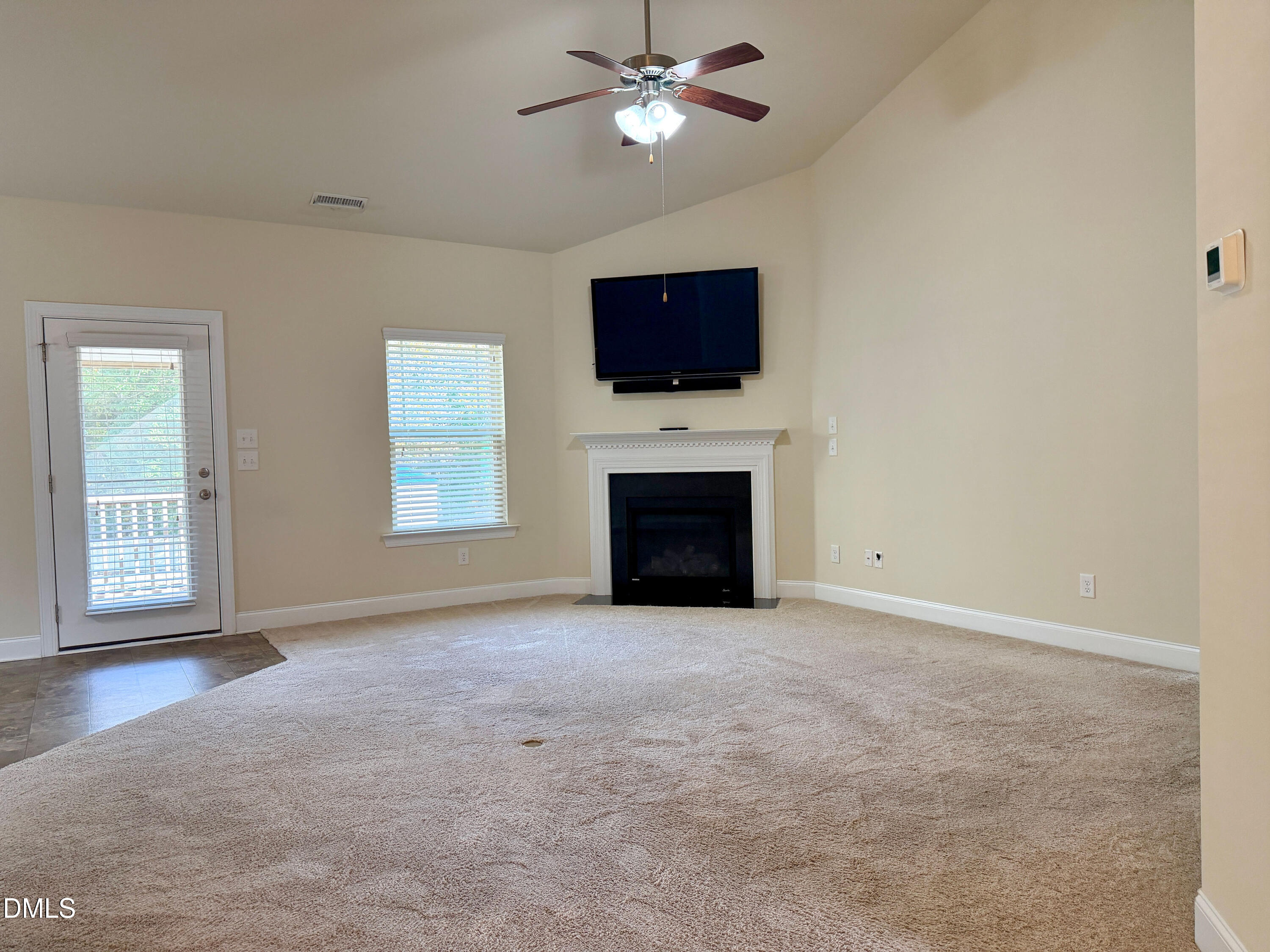 15 Cedar Falls Way Angier, NC 27501 - Photo 3 of 56 an empty room with windows fireplace and fan