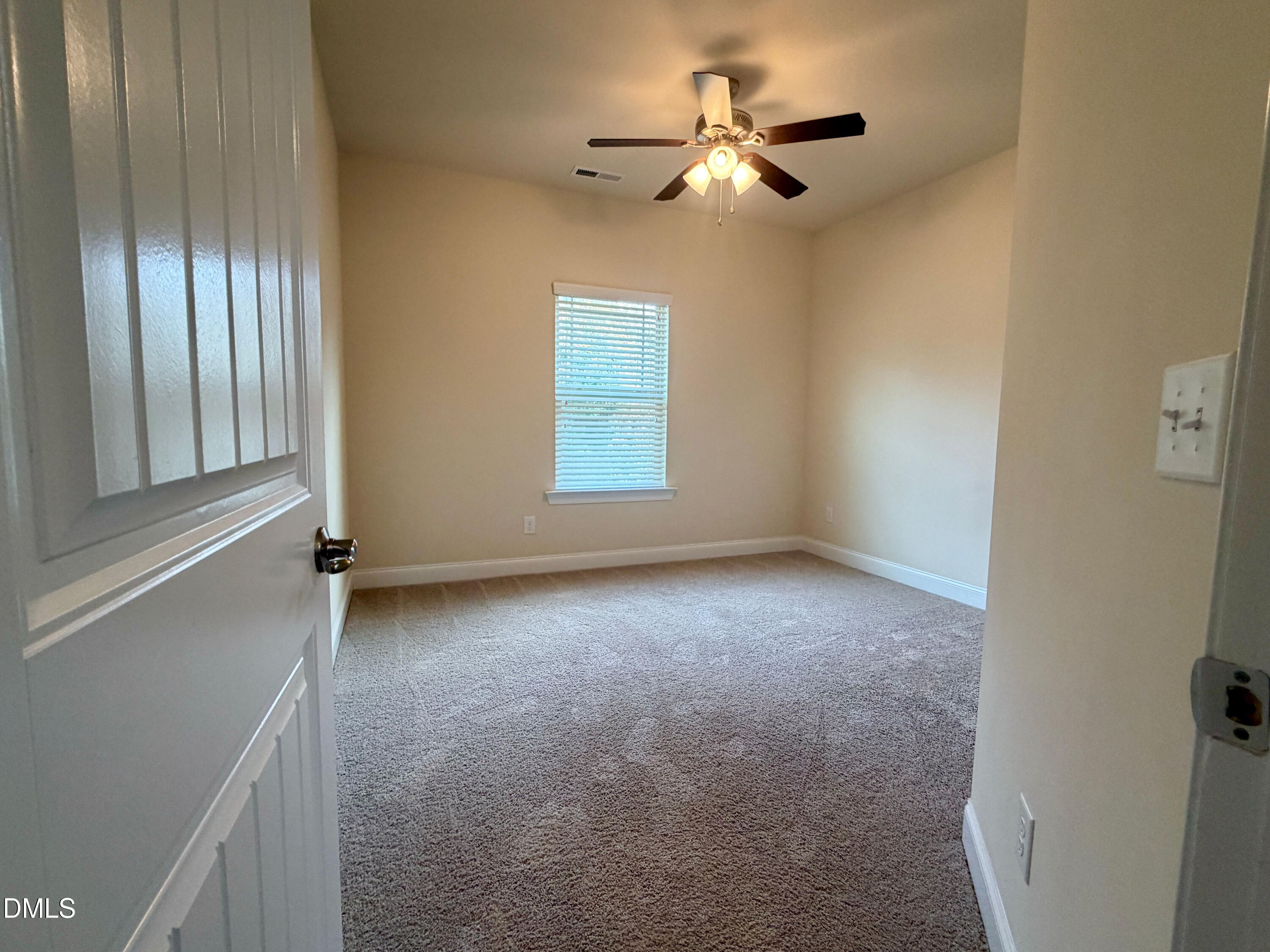 15 Cedar Falls Way Angier, NC 27501 - Photo 31 of 56 an empty room with chandelier fan and windows