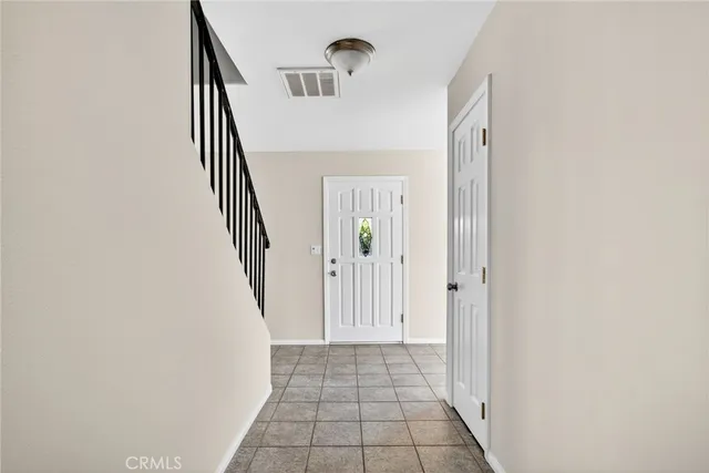 a kitchen with a stove a sink dishwasher and a refrigerator with wooden floor