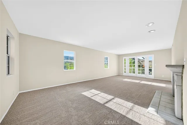 a kitchen with granite countertop a sink and white cabinets