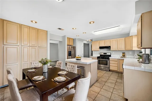 a spacious bedroom with a bed a couch and a window