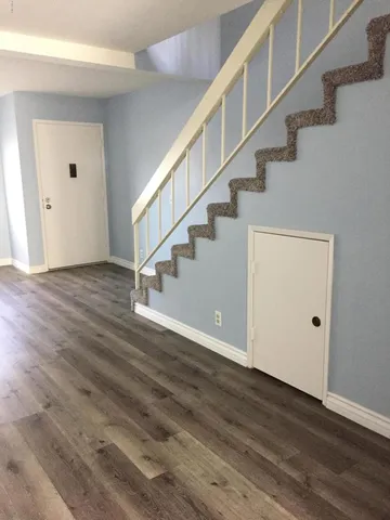a view of entryway and hall with wooden floor