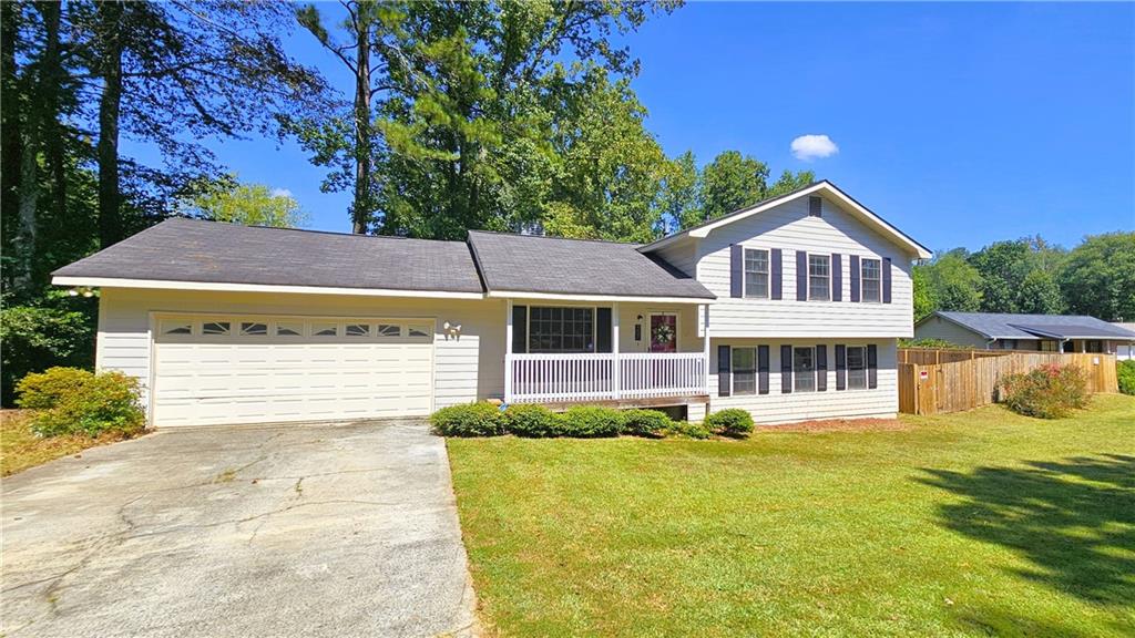 337 Independence Drive Jonesboro, GA 30238 - Photo 2 of 41 a front view of a house with a yard and garage