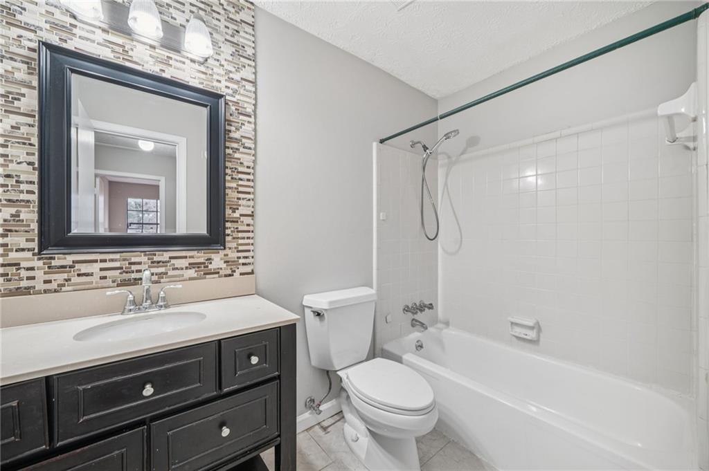 337 Independence Drive Jonesboro, GA 30238 - Photo 23 of 41 a bathroom with a sink a toilet and shower