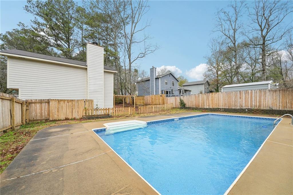 337 Independence Drive Jonesboro, GA 30238 - Photo 33 of 41 a view of a backyard with large tree and wooden fence