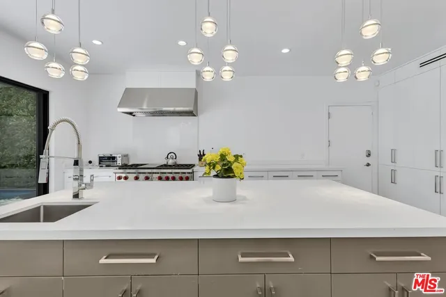 a bathroom with a sink a large mirror and vanity