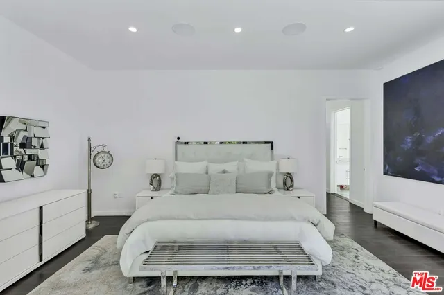a large white bed in a white room