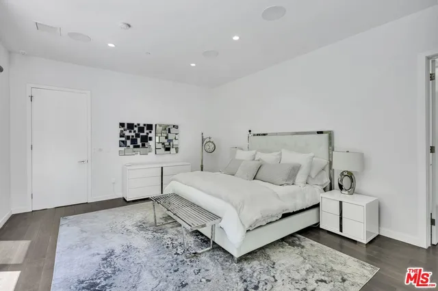 a bedroom with a bed and a night stand