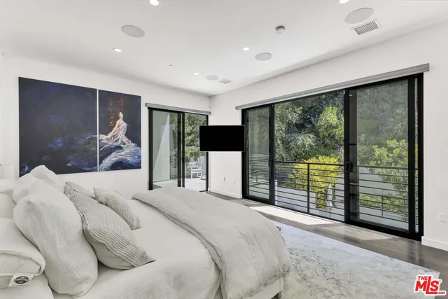 a bedroom with a large bed and a large window