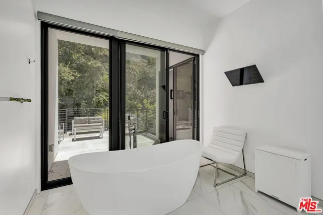 a living room with a large window and a table