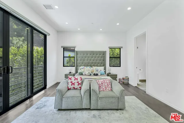 a bedroom with a large bed and a balcony view