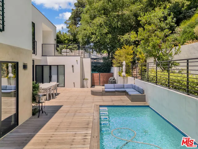a view of a house with backyard and sitting area