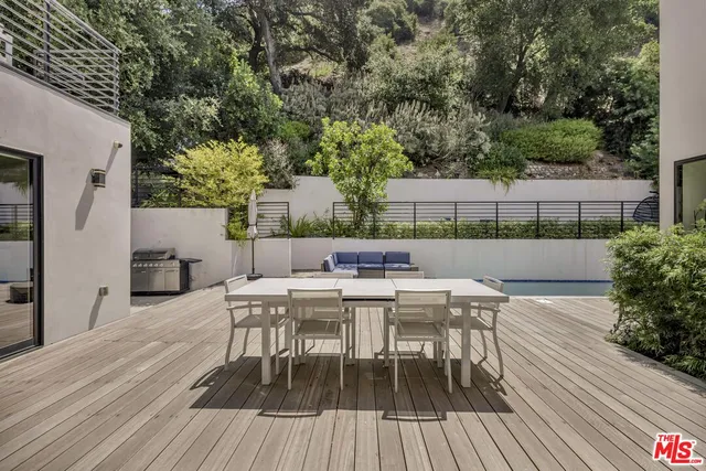 a view of a table and chairs in patio of the house