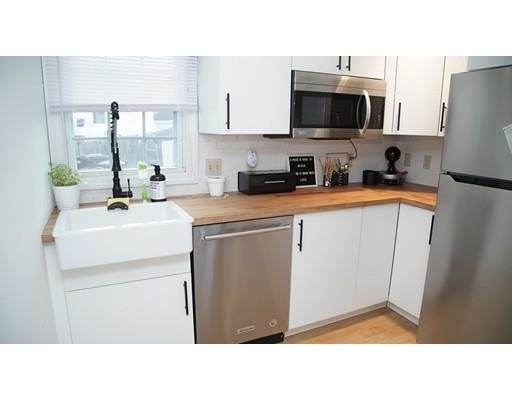 20 Milton Street Saugus, MA 01906 - Photo 7 of 30 a kitchen with sink a microwave a refrigerator and cabinets