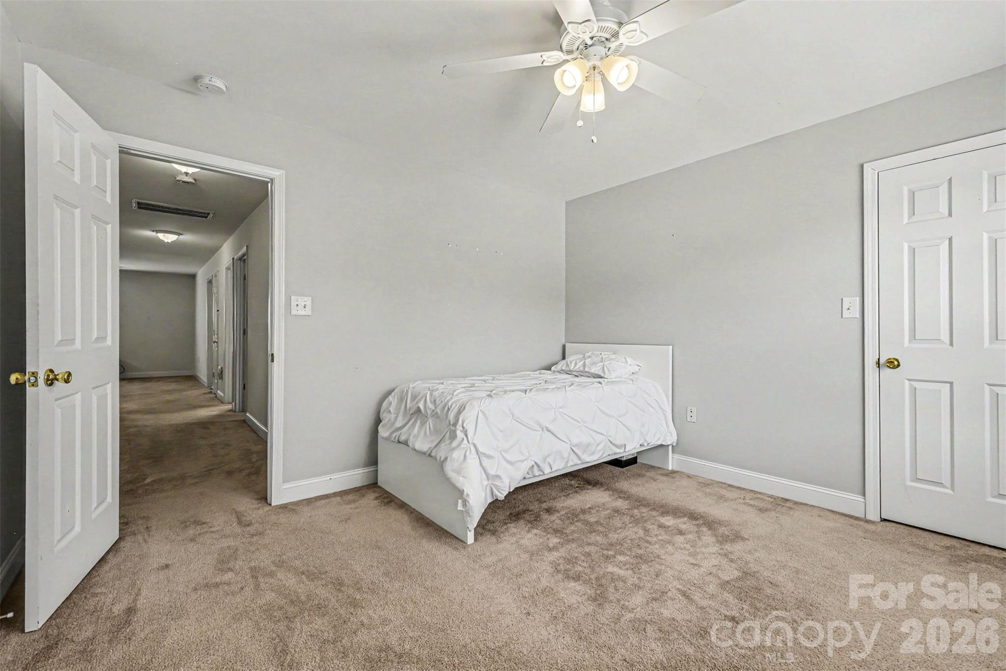 3035 Proverbs Court Monroe, NC 28110 - Photo 25 of 30 a spacious bedroom with a bed and a chandelier