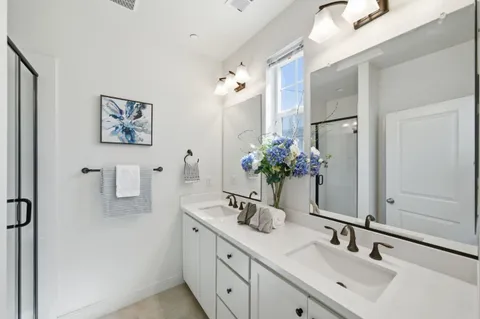 a bathroom with a sink double vanity and a mirror