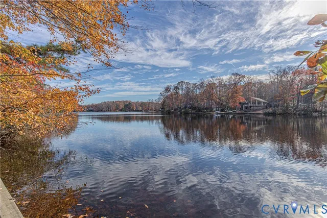 a living room with furniture a fireplace and a large window