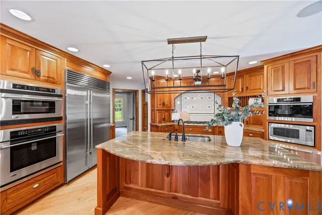 an empty room with wooden floor fireplace and windows