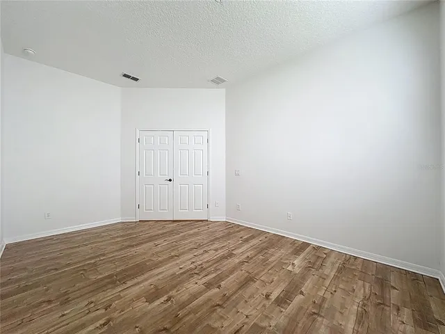 a bathroom with a granite countertop sink toilet a mirror and bathtub