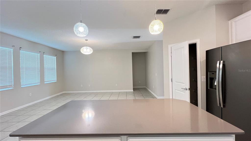 16466 Glassy Loch Loop Clermont, FL 34714 - Photo 26 of 37 an empty room with wooden floor and windows