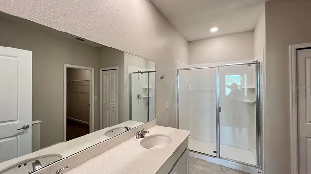 a spacious bathroom with a granite countertop sink a toilet and a mirror