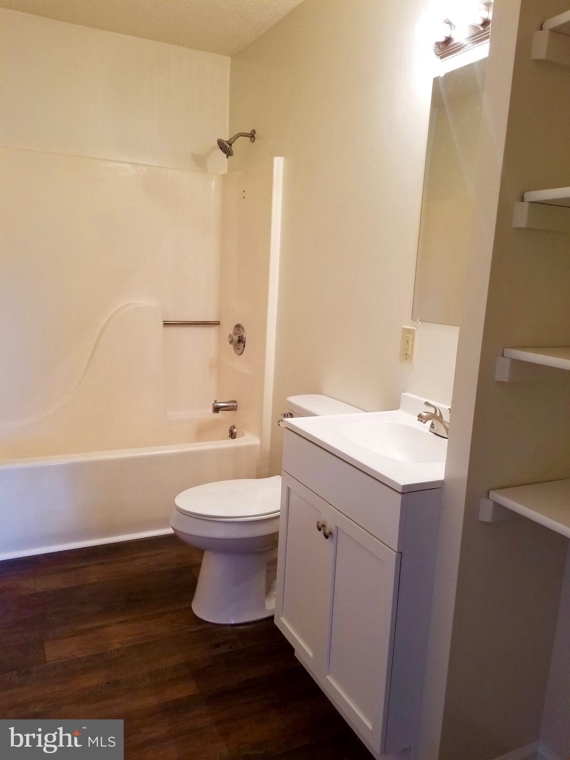 135 Truman Road Inwood, WV 25428 - Photo 17 of 30 a bathroom with a toilet a sink and bathtub