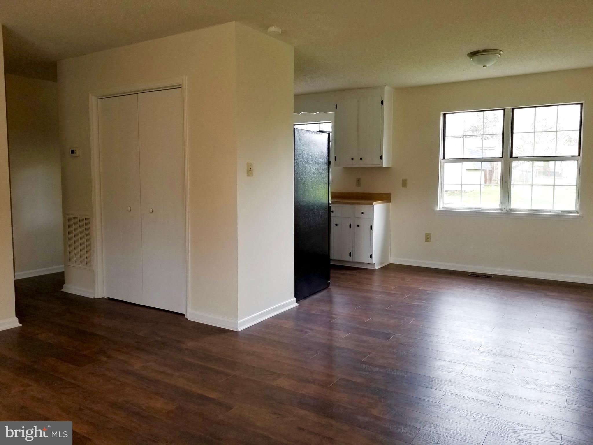 135 Truman Road Inwood, WV 25428 - Photo 6 of 30 an empty room with wooden floor and a window