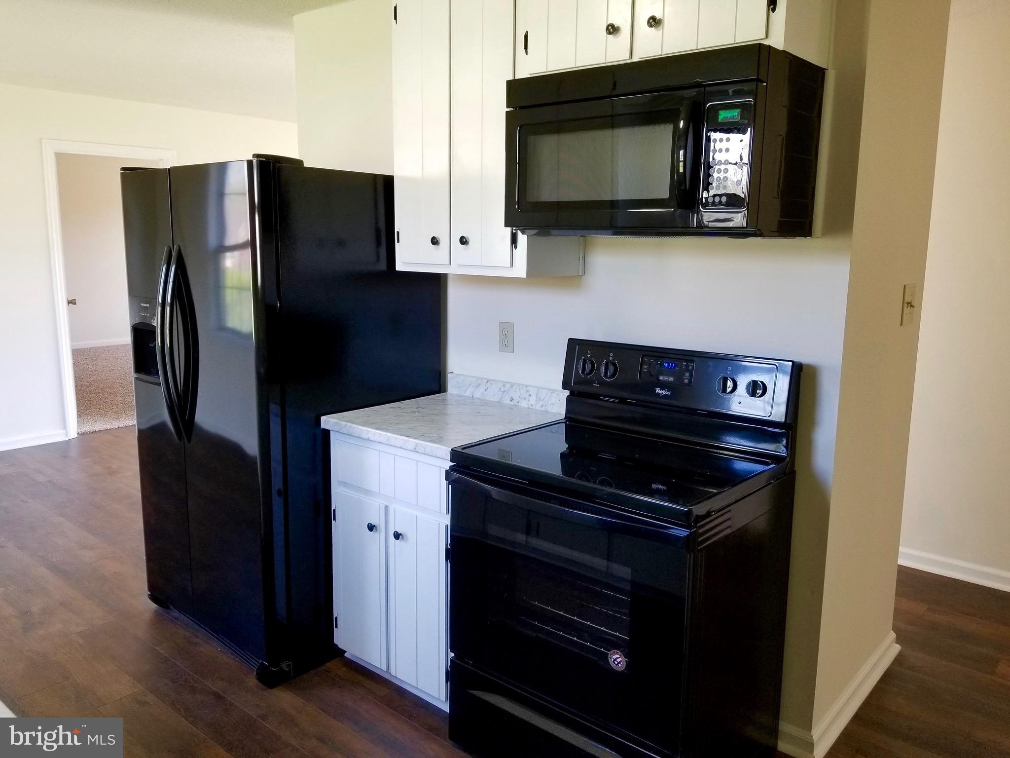 135 Truman Road Inwood, WV 25428 - Photo 8 of 30 a kitchen with a refrigerator stove and microwave