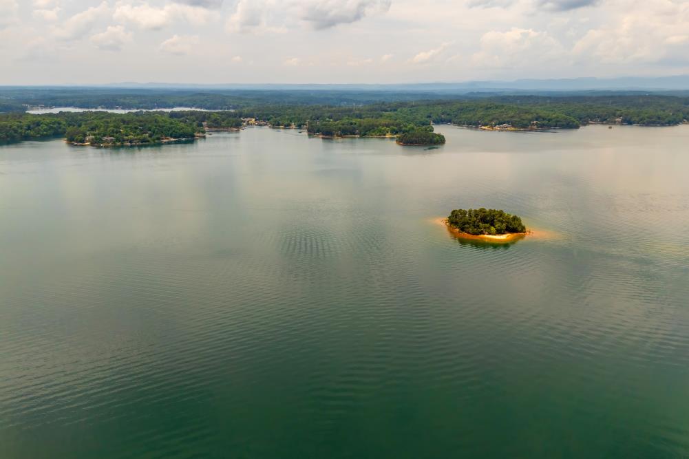 4 Warpath Ridge Trail Six Mile, SC 29682 - Photo 4 of 16 An aerial panorama reveals a vast, serene lake dotted with verdant islands and distant forested shorelines.